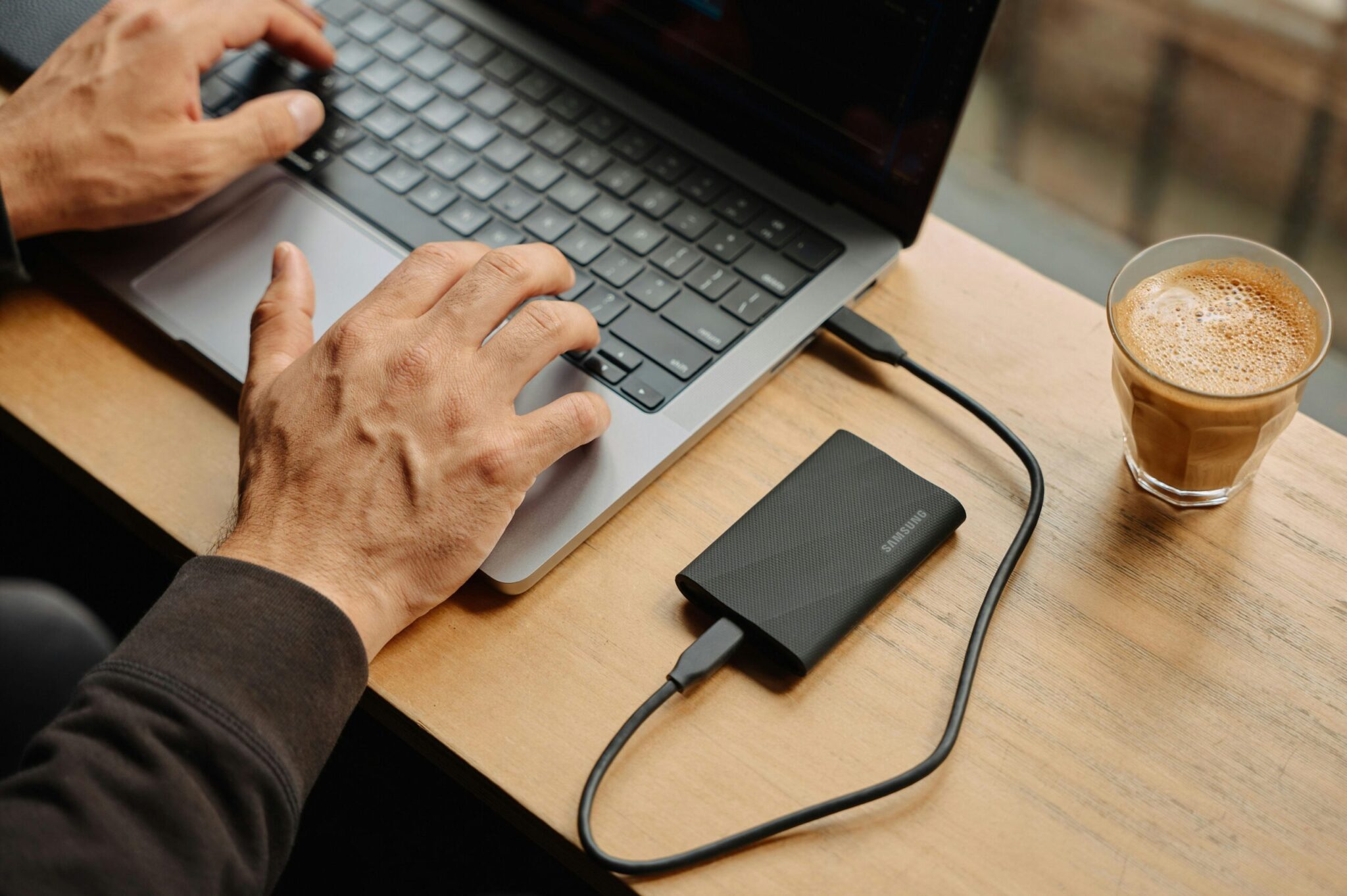 How-Much-Device-Storage-You-Need_-A-Comprehensive-Guide-scaledjpg | ALCON DTS: Austin, TX Best Managed IT Support Services A man sitting at a table using a laptop computer