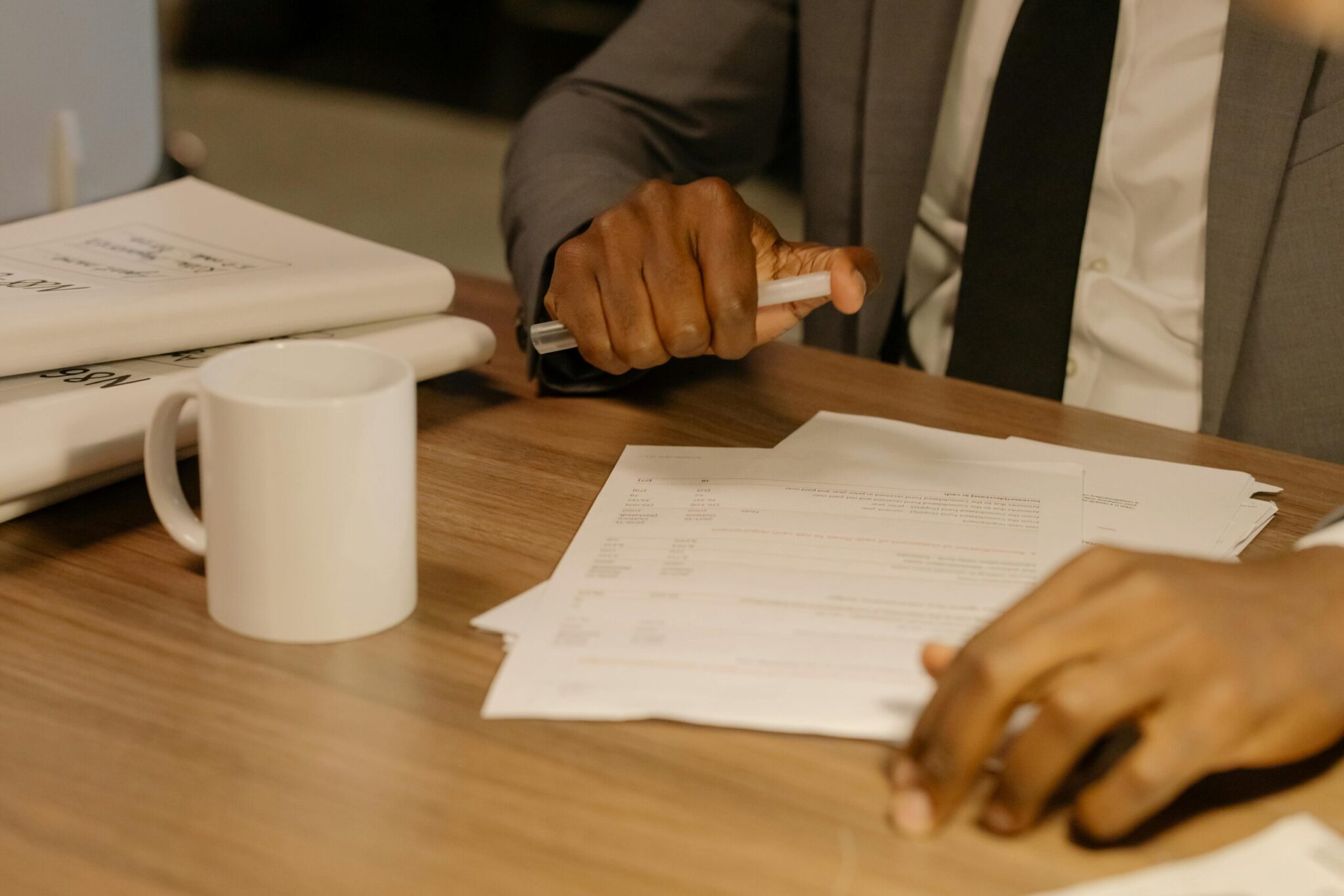 pexels-cottonbro-8369207-scaledjpg | ALCON DTS: Austin, TX Best Managed IT Support Services Free Close-up of a businessman holding and reviewing documents on a wooden desk. Stock Photo
