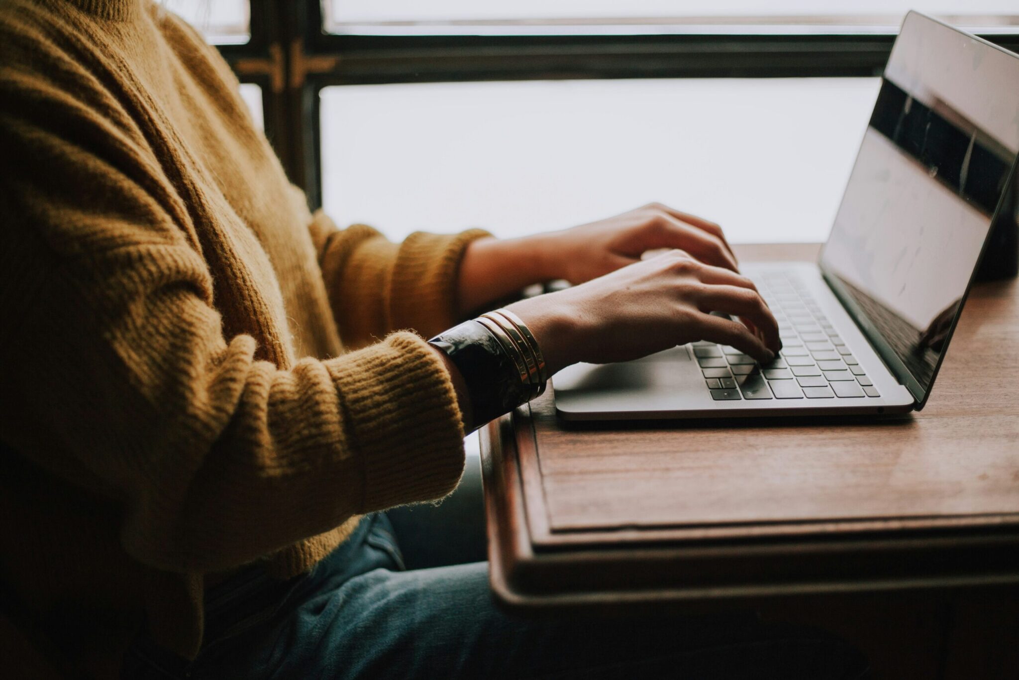 christin-hume-mfB1B1s4sMc-unsplash-scaledjpg | ALCON DTS: Austin, TX Best Managed IT Support Services person sitting front of laptop